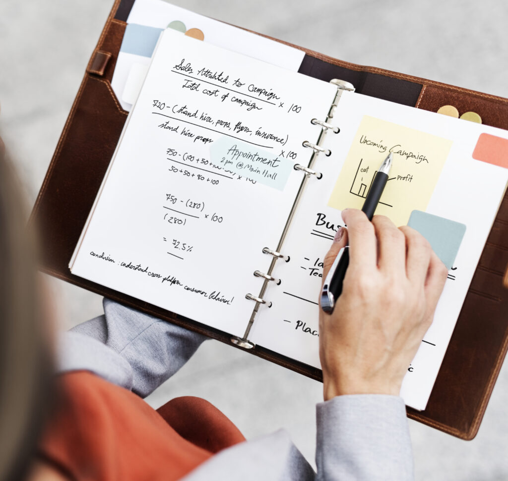 businesswoman-planning-writing-notebook-marketing-campaign-concept
