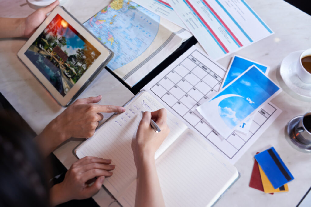 top-view-unrecognizable-people-planning-vacation-trip